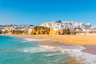 photo of an aerial view of wide sandy beach in touristic resorts of Quarteira and Vilamoura, Algarve, Portugal.