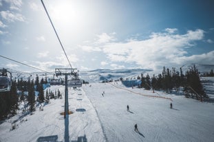 photo of beautiful vibrant aerial winter mountain view of ski resort Trysil, Norway. sunny winter day with slope, piste and ski lift.