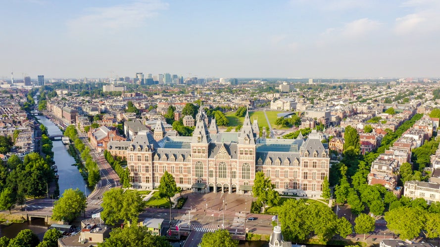 Amsterdam, Netherlands. Museum ( Rijksmuseum ). The building of the XIX century. Flying over the rooftops of the city, Aerial View