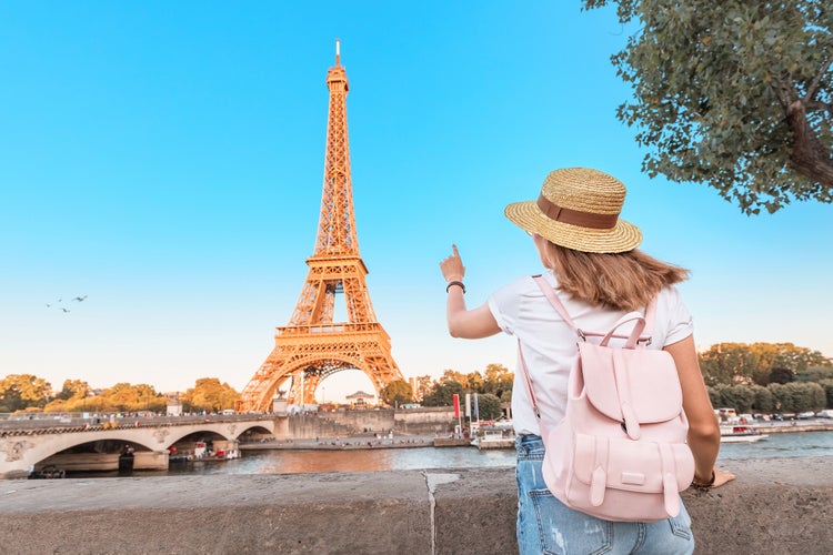 woman with backpack observing view of the Eiffel Tower in Paris.jpg