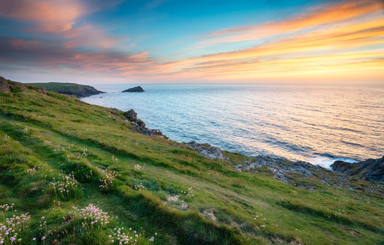 Photo of sunset on cliffs at West Pentire above Crantock near Newquay in Cornwall.