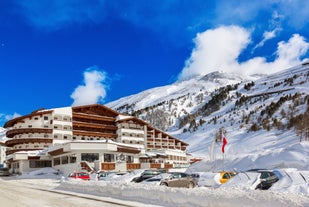 Photo of The mountain village at the Austrian ski resort Soelden on a cold and sunny winter day.