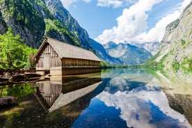 photo of historic town of Berchtesgaden with famous Watzmann mountain in the background on a sunny day with blue sky and clouds in springtime, National Park Berchtesgaden Land, Upper Bavaria, Germany.