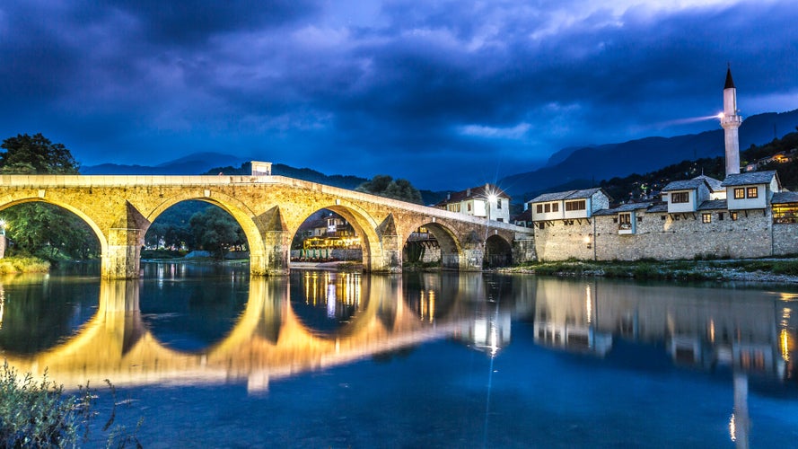 photo of view of Konjic Bosnia and Herzegovina old town bridge at night, neretva river and mosque, Konjic, Bosnia & Herzegovina.