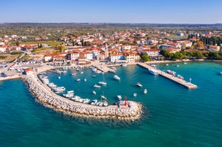 photo of an aerial view of the stunning Croatian coastal town of Pomer, with its picturesque oceanfront buildings and harbor.