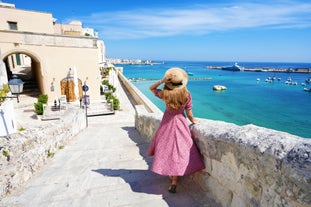 Photo of aerial view of Otranto town in Puglia with crystal turquoise waters, Italy.