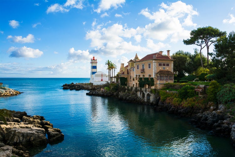 Photo of beautiful view of Cascais ,coastal resort and fishing town, with Santa Maria House and Lighthouse , Portugal.