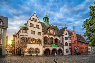 Photo of aerial view of the historic city center of Freiburg im Breisgau from famous old Freiburger Minster in beautiful evening light at sunset, Germany.