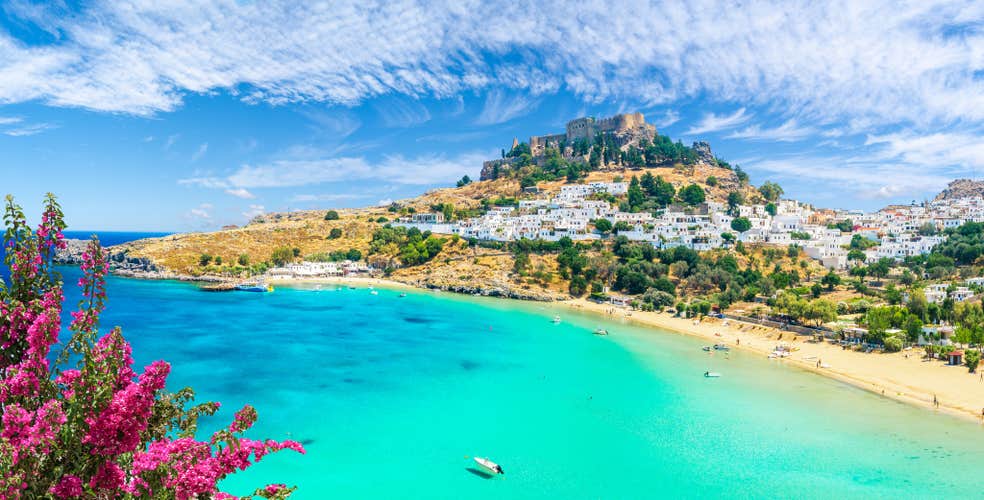 Photo of landscape with beach and castle at Lindos village of Rhodes, Greece.