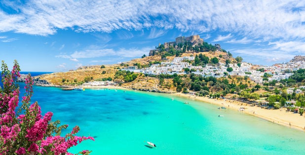 Photo of landscape with beach and castle at Lindos village of Rhodes, Greece.