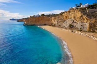 Photo of aerial panoramic view coastline and La Vila Joiosa Villajoyosa touristic resort townscape, sandy beach and Mediterranean seascape, Costa Blanca, Spain.