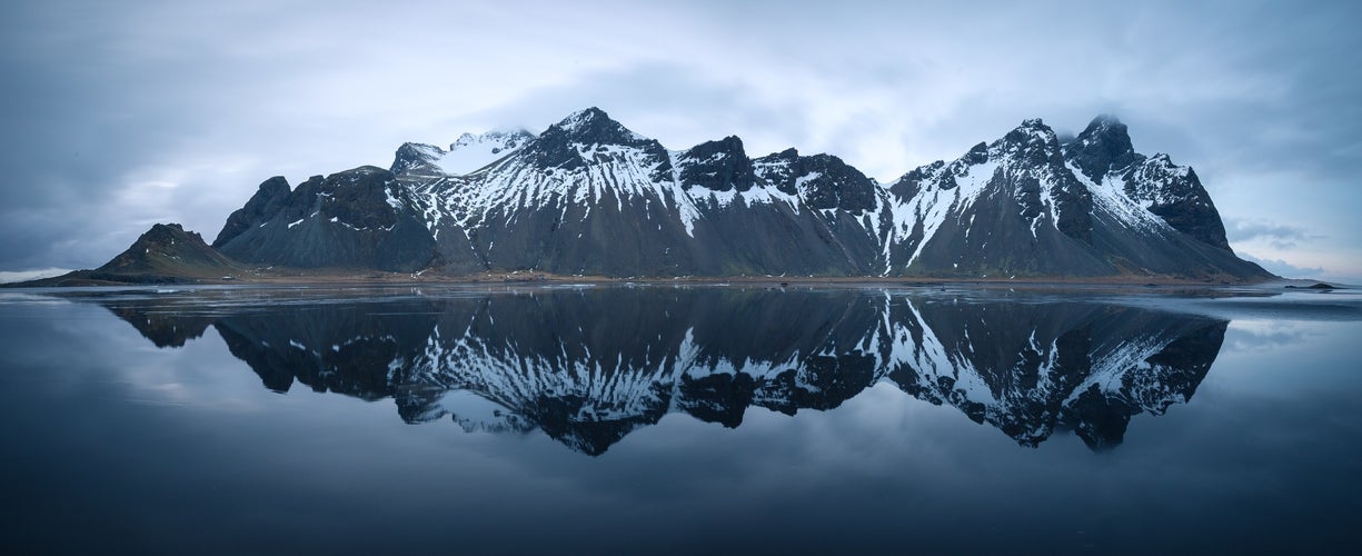 photo of view of Panorama of mirroring Vestrahorn at Stokksnes Iceland near Höfn, Iceland,