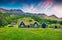 Photo of typical view of Icelandic turf-top houses with colorful summer sunrise in the Skogar village, south Iceland.