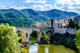 Photo of colorful yellow and orange houses and Eiffel Bridge, Old fish stalls, reflected in water river Onyar, in Girona, Catalonia, Spain.