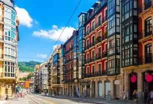 Photo of aerial view of Vizcaya bridge over the river and cityscape at Portugalete, Spain.