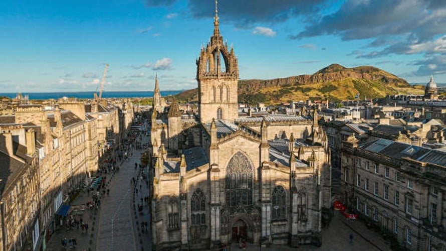 St. Giles Cathedral standing proudly in Edinburgh-s Old Town, with the iconic Arthur-s Seat rising in the background.jpg