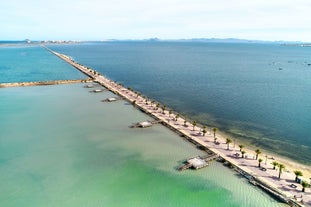 Photo of Beach seashore with wooden path to sea water in San Pedro del Pinatar