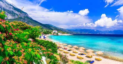 Photo of aerial view of Pythagorio port with colourful houses and blue sea, Samos island, Greece.