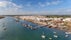 Photo of aerial view of pier fishing boats in the village Cabanas de Tavira, Portugal.