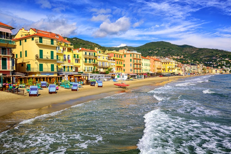 Empty mediterranean sand beach in traditional touristic town Alassio on italian Riviera by San Remo, Liguria, Italy