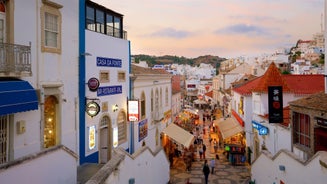 Photo of aerial cityscape of beautiful Tavira with roman bridge over Gilao river in the evening, Algarve, Portugal.