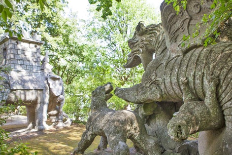 Dog Cerberus and the elephant Hannibal. Sculpture in the "Monster Park" or "Sacred Forest", Bomarzo, Italy