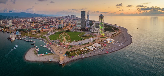 Photo of panoramic aerial view of Batumi, Georgia. The Ferris Wheel and the Alphabet Tower are in the foreground.