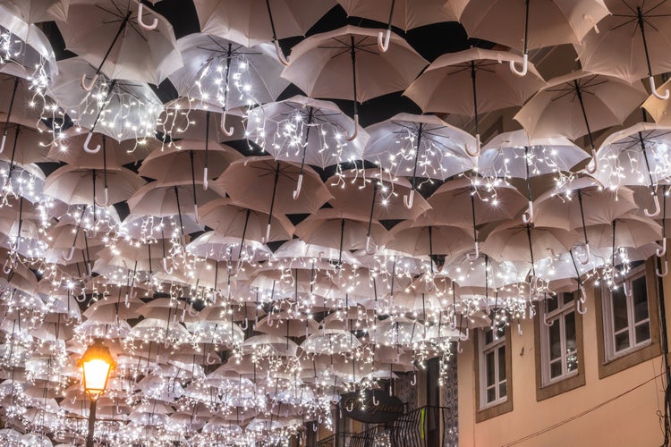 Photo of the beauty of white umbrellas illuminated by Christmas lights decorating the streets of Agueda ,Portugal.