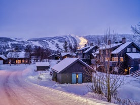 photo of panorama of ski resort with ski slopes and approaching snowstorm in Geilo, Norway.