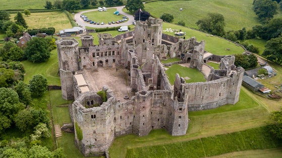 Photo of aerial view of a large medieval Raglan Castle showing the turrets, walls and moat ,South Wales.
