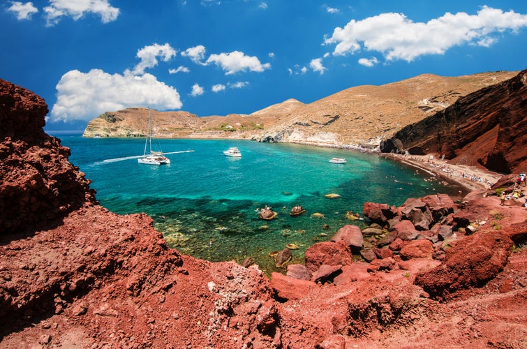 Photo of beautiful scenery of red sand beach in Akrotiri village ,Santorini ,Greece. One of the most famous beaches in the world.