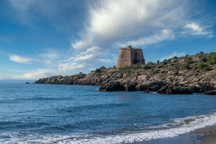 photo of Almuñécar, Spain - A scenic view of a coastal city with white buildings and a blue ocean in the background.