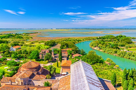 photo of Aerial view of Santa Maria di Assunta cathedral on Torcello island in Venice lagoon, Italy.