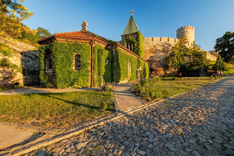 Photo of Belgrade fortress and Kalemegdan park with dramatic clouds.