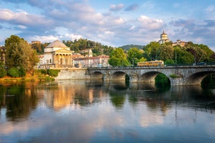 Photo of aerial view of Verona historical city centre, Ponte Pietra bridge across Adige river, Verona Cathedral, Duomo di Verona, red tiled roofs, Veneto Region, Italy.