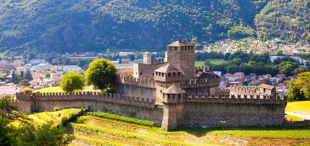 Photo of summer view of medieval fortified Montebello Castle protecting old city of Bellinzona on foothills of Swiss Alps, Switzerland. 