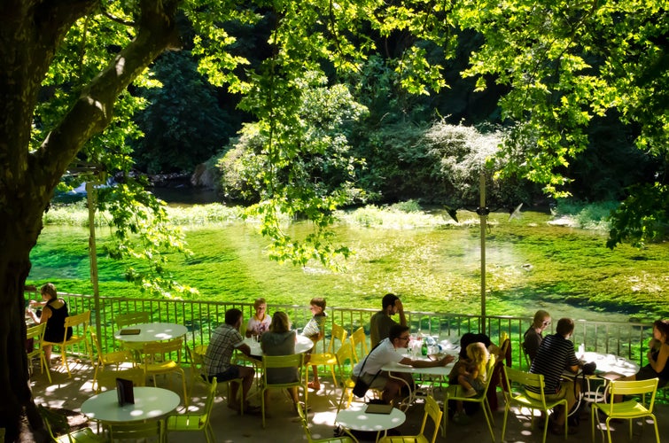 The green river Sorgue with a café in L-Isle-sur-la-Sorgue a town known for his antique shops.jpg