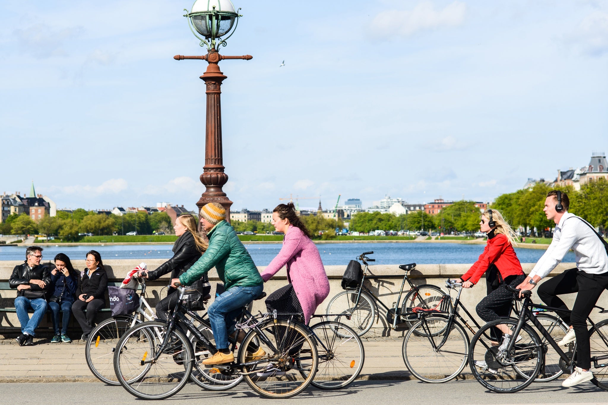 Group of people riding bicycles crossing Queen Louise Bridge.jpg