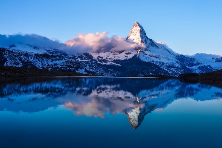 photo of Matterhorn in early morning with reflection in Stellisee in winter, Zermatt, Switzerland.