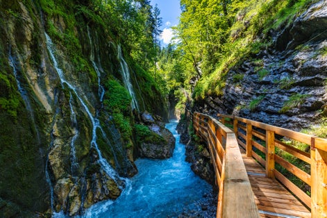 Photo of Beautiful Wimbachklamm gorge with wooden path in autumn colors, Ramsau bei Berchtesgaden in Germany. Waterfall at Wimbachklamm near Ramsau-Berchtesgaden, Bavaria, Germany.