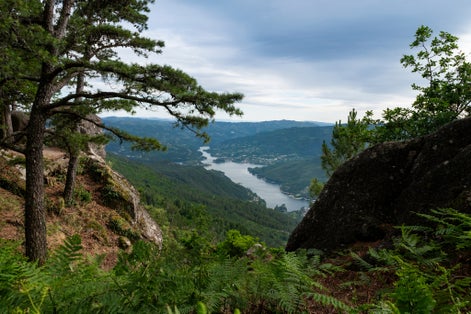 Photo of Scenic view of the lake at the Canicada Dam and the surrounding mountains from the Pedra Bela viewpoint at the Peneda Geres National Park, in Portugal, Europe.