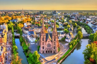 Photo of traditional half-timbered houses on picturesque canals in La Petite France in the medieval fairytale town of Strasbourg, France.