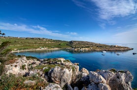 Photo of aerial view of seaside cliffs, colourful houses and streets of Qawra town in St. Paul's Bay area in the Northern Region, Malta.