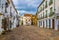 photo of the small square Plaza del Potro in the Spanish city cordoba in Spain, which is surrounded by many restaurants, tourist shops and an ancient fountain.