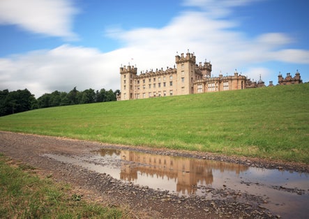 Photo of Long exposure of Floors Castle in the Scottish borders reflecting on a puddle.
