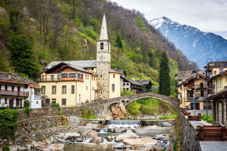 Fontainemore alpine village on the Lys river in a forest in the valley of Gressoney near Monte Rosa during spring. Aosta Valley, Aosta, Italy.