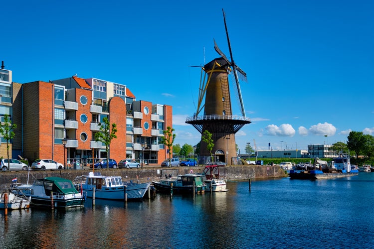 View of the harbour of Delfshaven with the old grain mill known as De Destilleerketel. Rotterdam, Netherlands