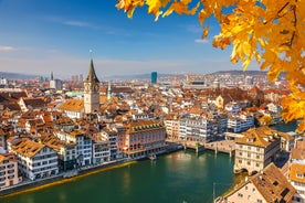 Geneva skyline cityscape, French-Swiss in Switzerland. Aerial view of Jet d'eau fountain, Lake Leman, bay and harbor from the bell tower of Saint-Pierre Cathedral. Sunny day blue sky.