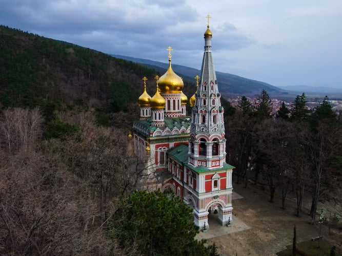 photo of view of Aerial view of Shipka Memorial Church in Bulgaria. Drone view of Monastery Holy Nativity, known as Russian church in town of Shipka, Stara Zagora Region, Bulgaria. Birth of Christ with Golden domes.