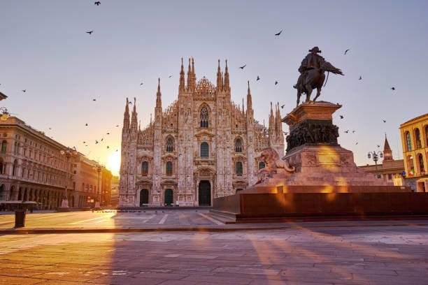 The Duomo di Milano (Milan Cathedral) and the Piazza del Duomo illuminated by the warm hues of sunset..jpg